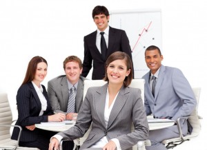 Charming businesswoman sitting in front of her team